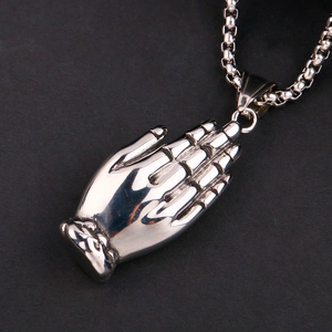 Polished stainless steel praying hands pendant with square link chain on black background