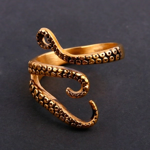 Macro detail of vintage gold octopus tentacle ring showing realistic suction cup textures