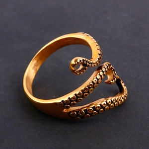 Macro shot of vintage gold octopus tentacle ring details with textured suction cups