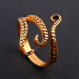 Macro detail of octopus tentacle ring featuring suction cup textures and vintage gold finish
