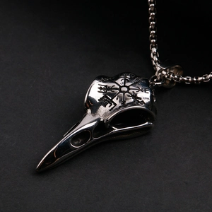 Detail of Viking crow skull necklace with Vegvisir compass engraving and bead chain