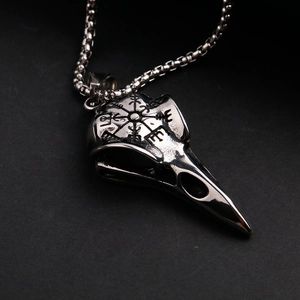 Macro detail of Viking Vegvisir symbol engraved on a stainless steel raven skull pendant