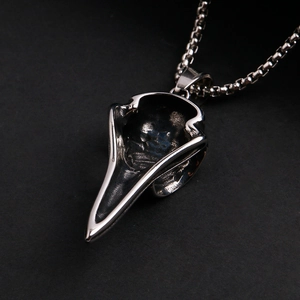Macro shot of vintage Viking raven skull pendant with oxidized stainless steel details