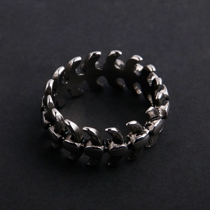 Macro shot of vintage stainless steel fish bone ring with detailed punk spinal structure