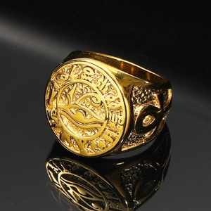 Macro detail of gold Eye of Horus signet ring with vintage Egyptian relief carvings