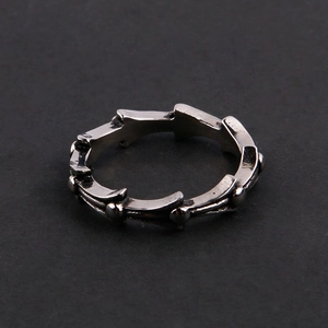 Detailed view of vintage stainless steel ring with industrial thorn texture and beads