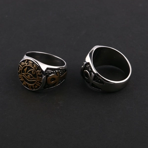 Macro detail of Egyptian Eye of Horus and Ankh symbols on two-tone stainless steel rings