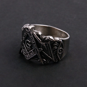 Macro view of vintage Freemasonry stainless steel ring featuring relief engraving
