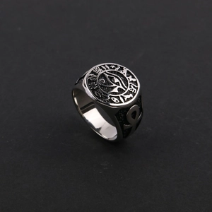 Macro detail of vintage Horus eye and Ankh symbols on a stainless steel ring