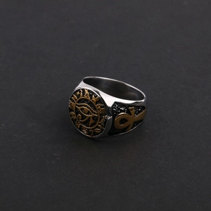 Macro shot of gold Eye of Horus relief and Ankh cross details on vintage steel ring