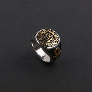 Detailed close-up of vintage Eye of Horus ring with gold Egyptian symbols on silver band