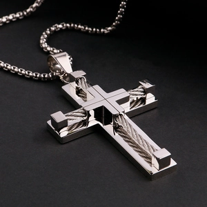Macro shot showing woven steel wire texture on stainless steel cross pendant necklace