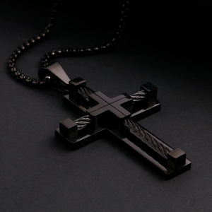 Close-up of black double-layered stainless steel cross pendant with wire details
