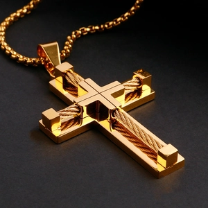 Close-up of golden cross pendant with industrial wire detail and beaded chain