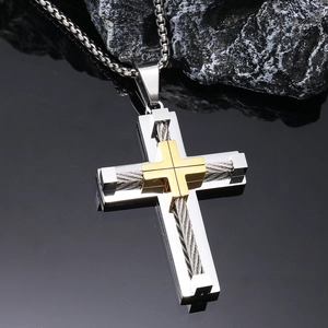 Close-up of dual-layer stainless steel cross pendant with twisted wire and gold accents