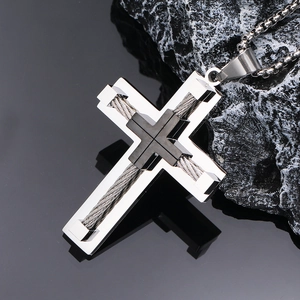 Close-up of double-layer stainless steel cross pendant with steel wire texture details