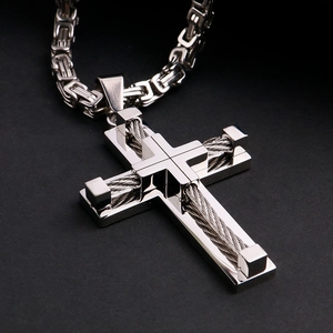 Macro shot of silver stainless steel cross pendant with industrial steel wire inlay detail