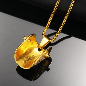 Macro view of gold titanium steel welding helmet pendant with detailed matte interior texture