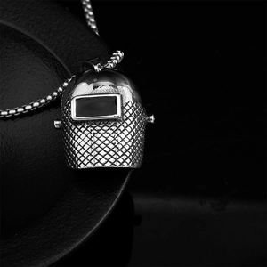 Macro view of industrial welding helmet pendant with detailed diamond grid pattern