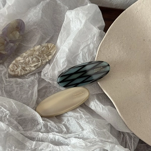 Set of 4 elegant acetate oval hair clips in marble and cream patterns for women