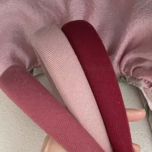 Three knitted berry-colored headbands with ribbed texture for a high-top volume look