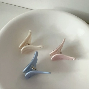 Star and wing butterfly hair clips in pastel blue, cream white, and pink resin