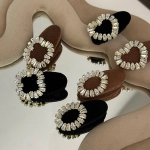 Detailed view of six vintage rhinestone hair clips with black and mocha velvet texture