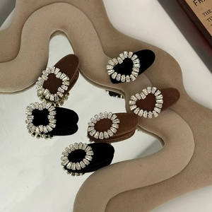 Detail of vintage velvet hair clips with sparkling rhinestones in black and coffee brown