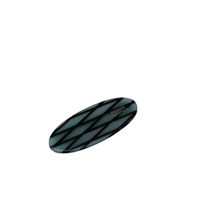 Oval acetate hair clip in emerald green with black lattice pattern and gold engraving