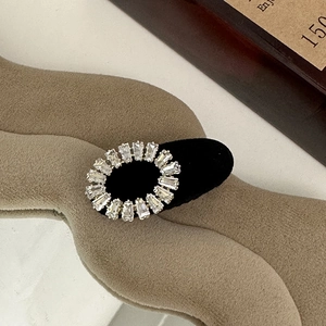 Detailed view of vintage black velvet hair clip with sparkling rectangular rhinestones