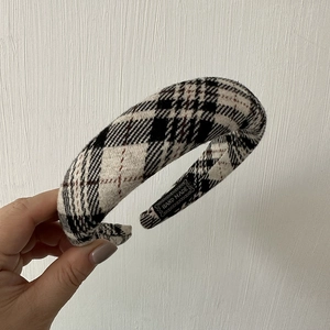 Detail showing the handmade label and texture of the black and white plaid wide headband