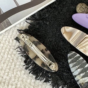 Elegant acetate spring hair clips set with leopard and tortoiseshell patterns in macro view