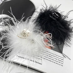 Elegant ostrich feather claw clip in black and white colors for luxury hair styling