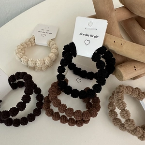 Textured knit hair scrunchies set in earth tones with stylish ball-shaped pattern