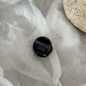 Detailed macro view of small black acetate hair claw with gold France Handmade logo