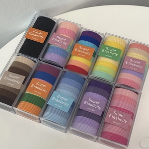 Detailed view of ten boxes of assorted colorful high-elasticity hair ties for women