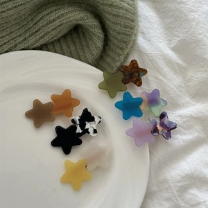 Set of colorful acetate star hair clips in tortoiseshell and marble patterns