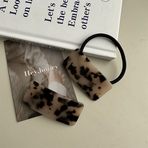 Detail of tortoiseshell acetate hair clip and tie with France Handmade gold lettering