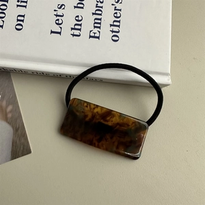 Close-up of rectangular tortoiseshell acetate hair clip with premium metal spring mechanism