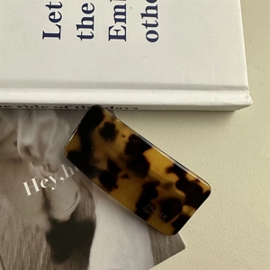 Detail view of handmade rectangular acetate hair clip with classic tortoiseshell pattern