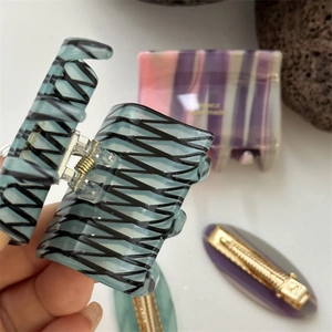 Blue marbled acetate hair claw clip with wave pattern and strong metal spring