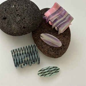 Set of four striped acetate hair clips including shark jaw claws and oval side pins