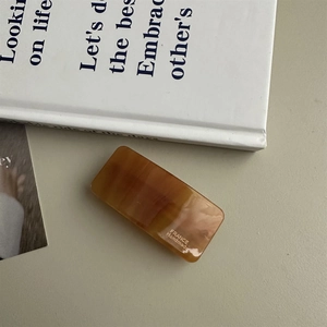 Detailed macro view of rectangle tortoiseshell acetate hair clip with France Handmade logo