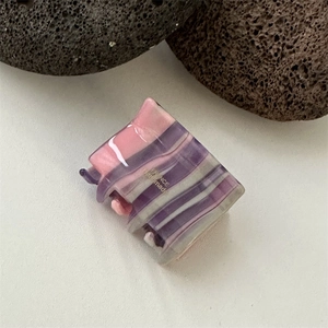Detail of pink and purple tortoiseshell acetate hair claw with France Handmade gold foil