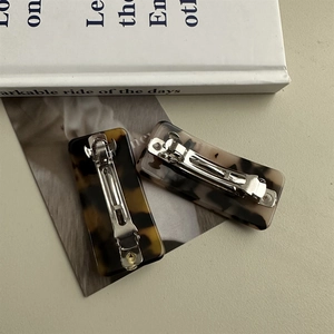 Elegant rectangular acetate hair clips set in tortoiseshell and marble texture finishes