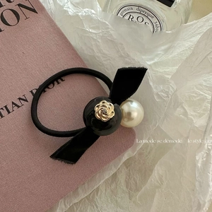 Elegant camellia pearl hair tie with black velvet bow and golden rose charm detail