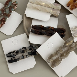 Detailed macro view of assorted vintage twisted acetate hair clips with marble patterns