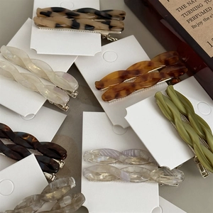 Retro acetate twisted hair clips in leopard and marble patterns with metal duckbill base