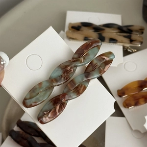 Vintage tortoiseshell acetate twist hair clips in various marble patterns for women
