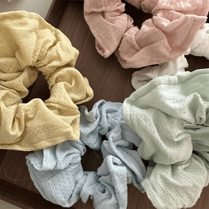 Detail showing knit texture and macaron colors of five pleated soft hair scrunchies